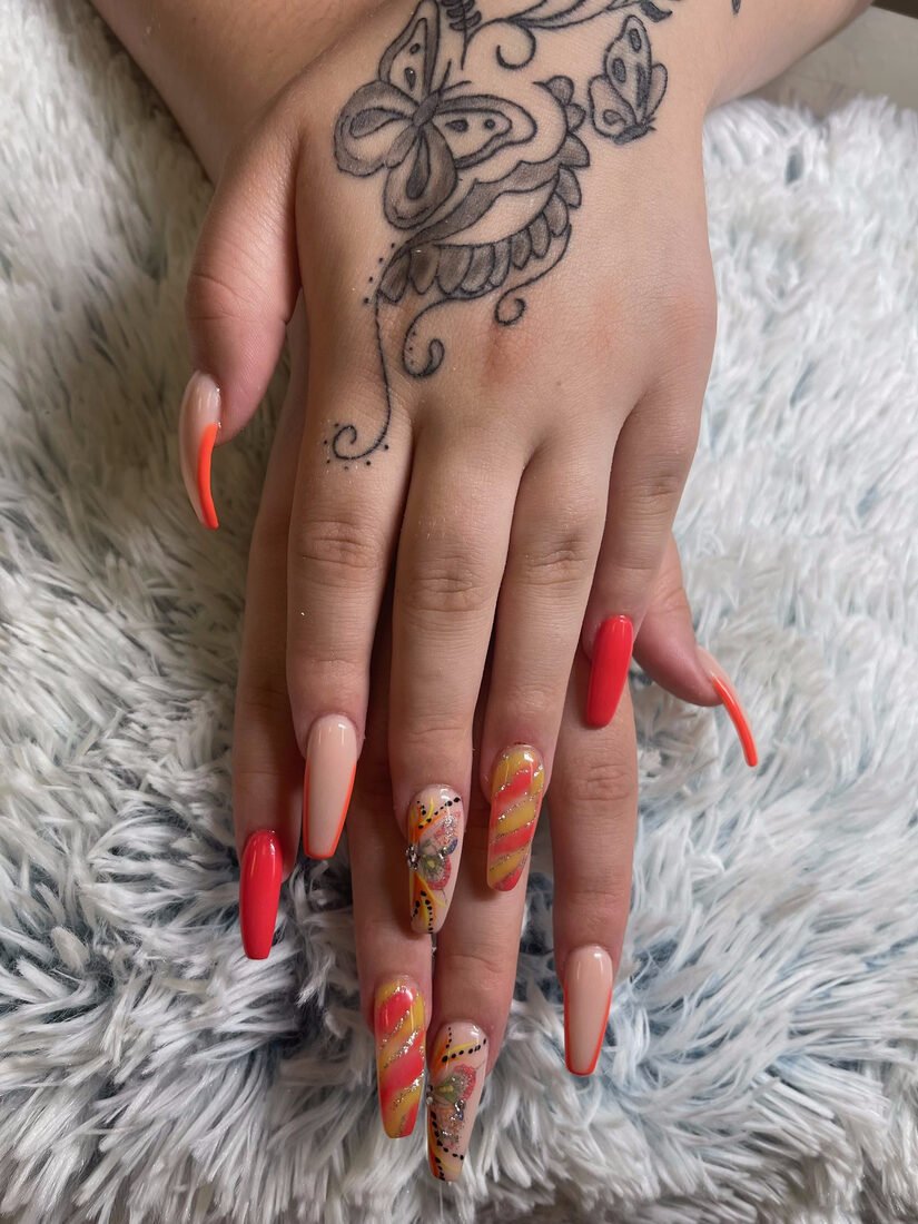 Long coral stiletto set with gold and hand-painted accent nails
